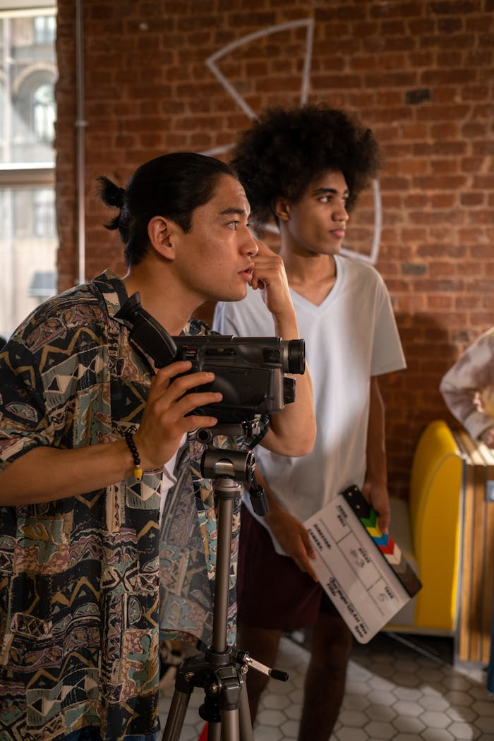 About Filmmakers capturing a creative scene in an urban café setting, emphasizing teamwork and diversity.